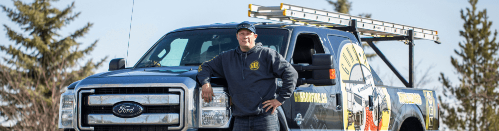 Guns N Hoses Roofing contractor standing beside branded truck before starting work.