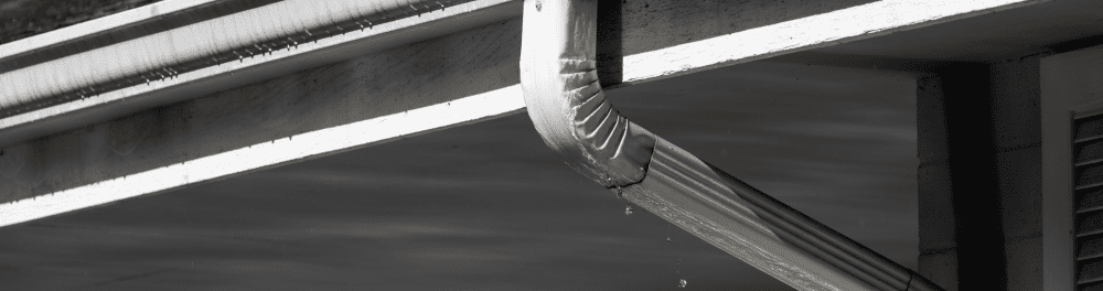 A close up image of a gutter in a rainstorm.